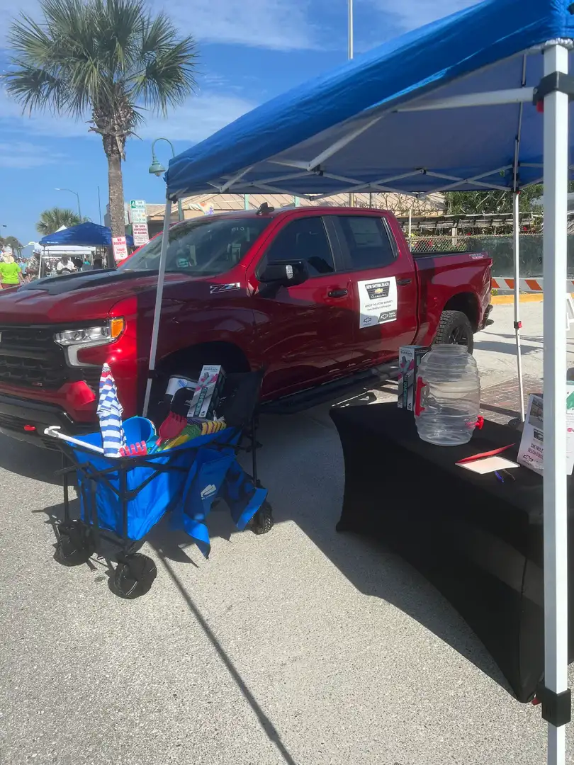 New Smyrna Beach Chevrolet supporting a community event on Flagler Avenue with a Chevrolet Silverado display