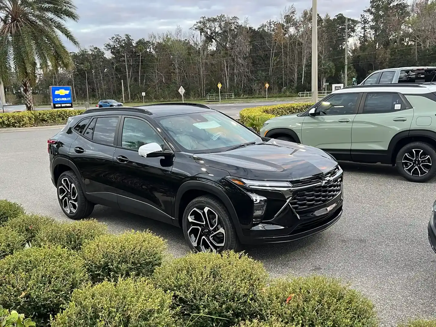 Drivers comparing Chevrolet SUVs and trucks at New Smyrna Beach Chevrolet
