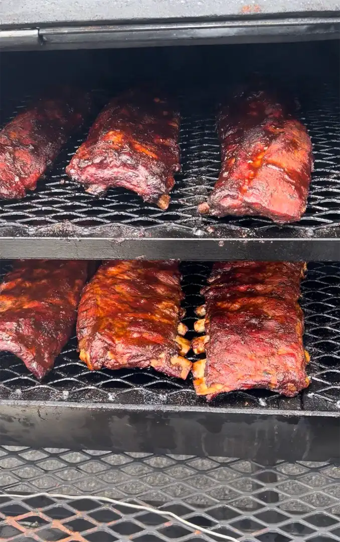 Ribs cooking on smoker for BBQ competition