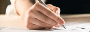 Woman signing paperwork for car