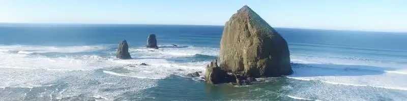 Haystack Rock and beach with waves