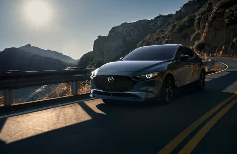 2021 Mazda3 Sedan driving down a rural road
