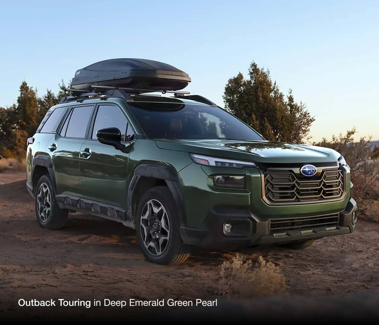 Subaru Outback Touring in Deep Emerald Green sitting in desert landscape
