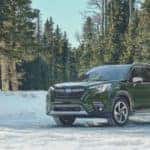 2022 Subaru Forester parked by a snowbank in a forest