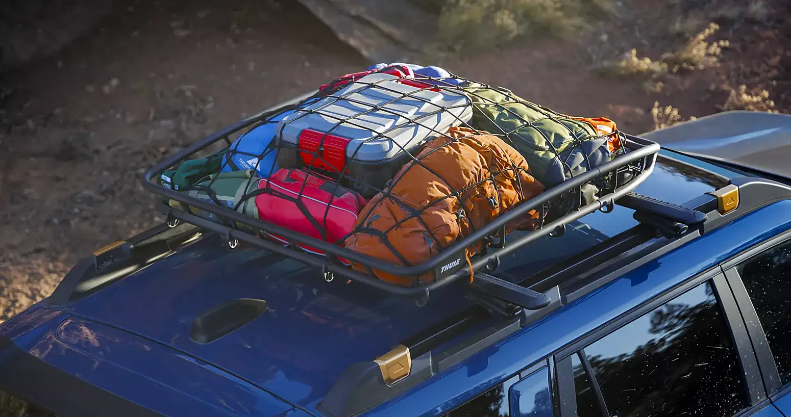 2026 Subaru Outback roof rack loaded with camping gear and secured cargo for an outdoor adventure.