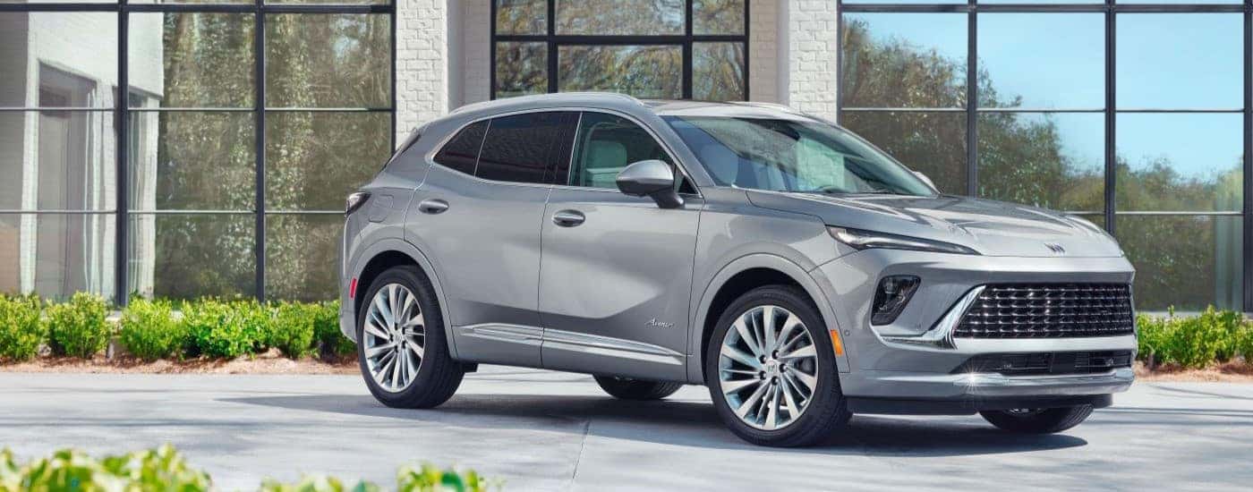 Grey 2024 Buick Envision parked in front of a house