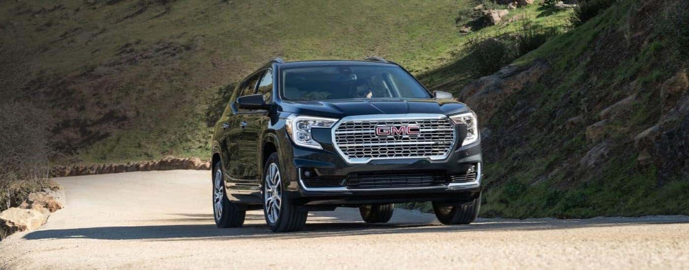 Black 2022 GMC Terrain Denali driving after looking at used GMCs for sale