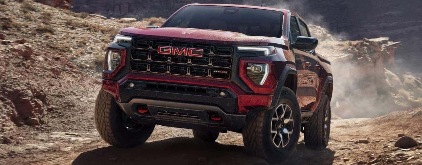 Red 2023 GMC Canyon AT4X driving on a trail