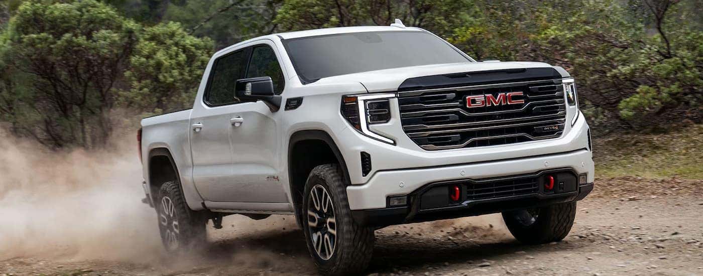 A white 2025 GMC Sierra 1500 AT4 off-roading for sale