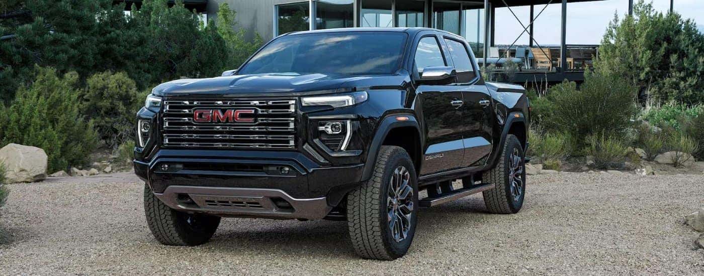 Black 2025 GMC Canyon Denali parked outside a house