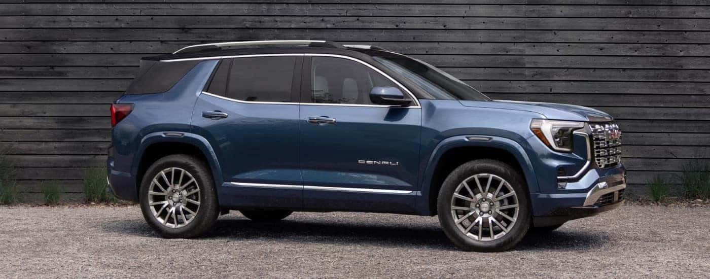 Blue 2026 GMC Terrain Denali parked outside of a GMC dealer near Orlando