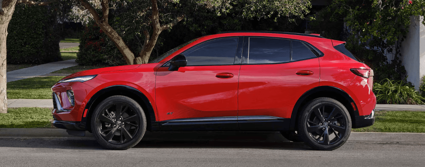Red 2026 Buick Envision parked under a tree