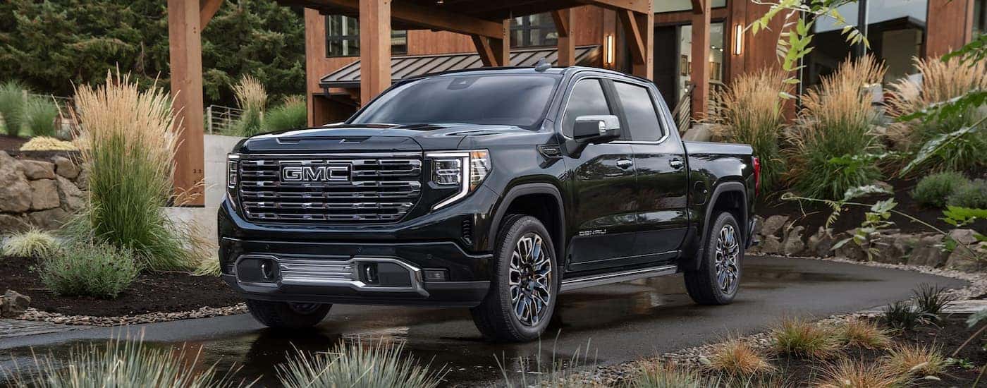 Black 2026 GMC Sierra 1500 parked outside a building.