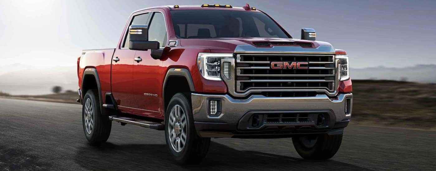 A red 2021 GMC Sierra 2500 shown driving.