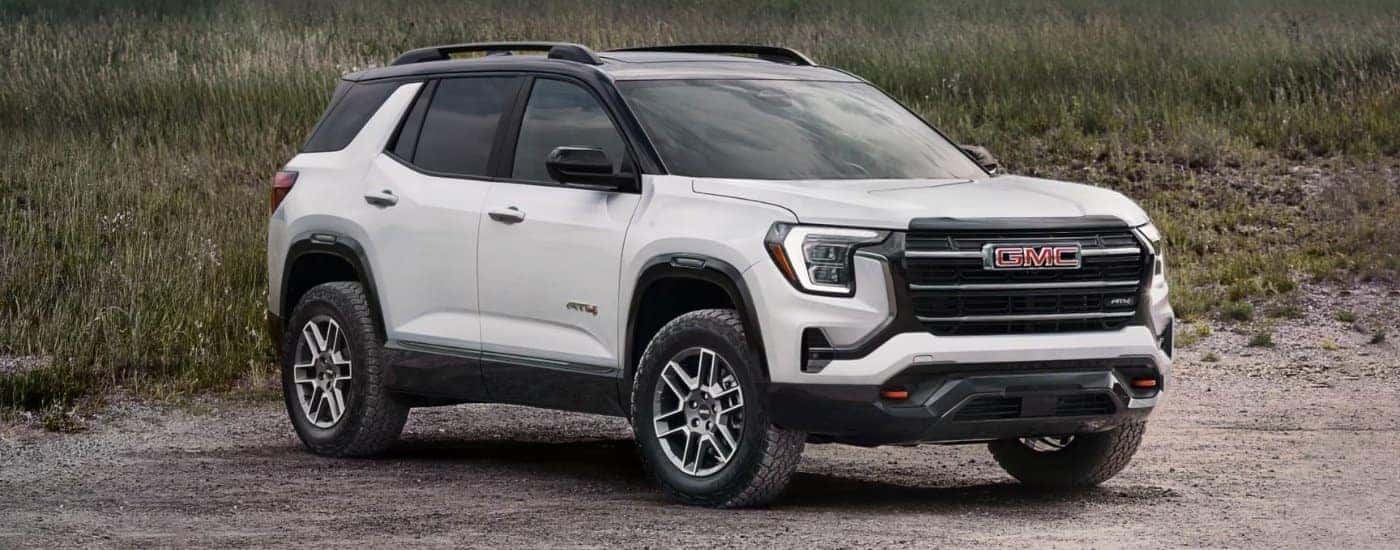 A white 2026 GMC Terrain AT4 shown parked on the beach.