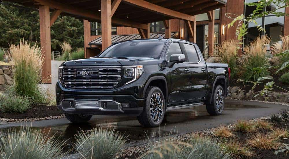 A black 2026 GMC Sierra 1500 parked in a driveway.