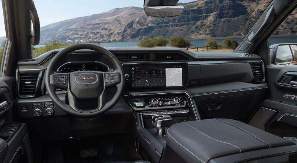 Interior view of a 2026 GMC Sierra 1500 infotainment, steering wheel and gauge cluster.