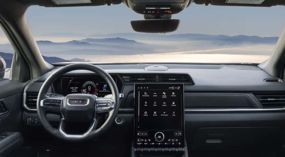 Interior view of a 2026 GMC Terrain infotainment, steering wheel and digital gauge cluster.