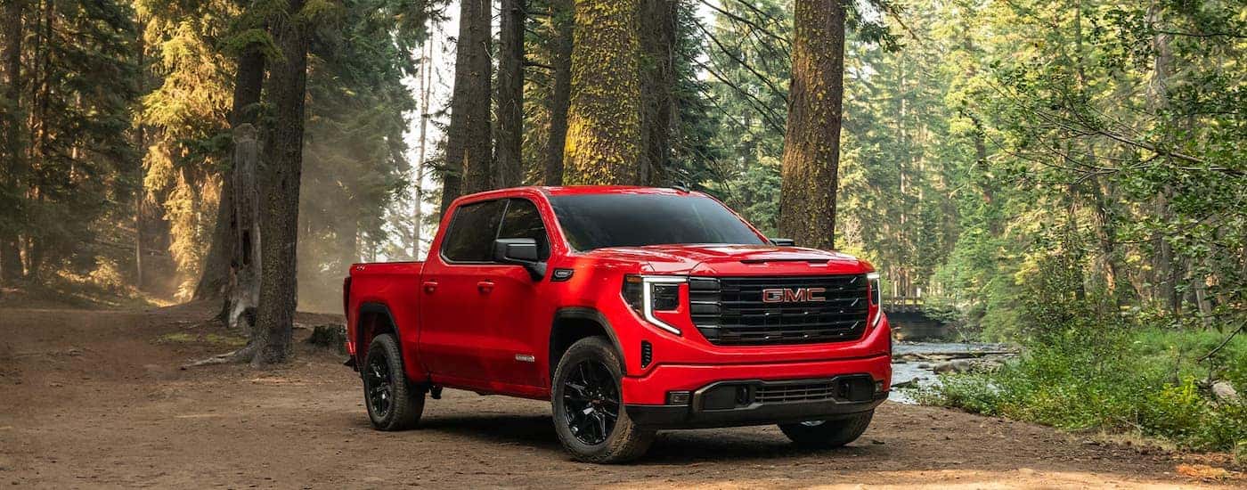 Red 2026 GMC Sierra 1500 in the forest.