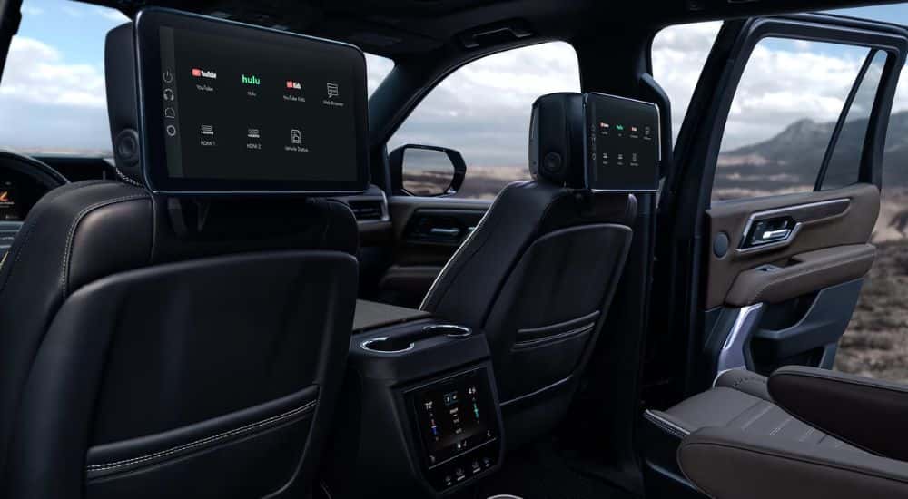 View of entertainment screens on the rear seats of a 2026 GMC Yukon.