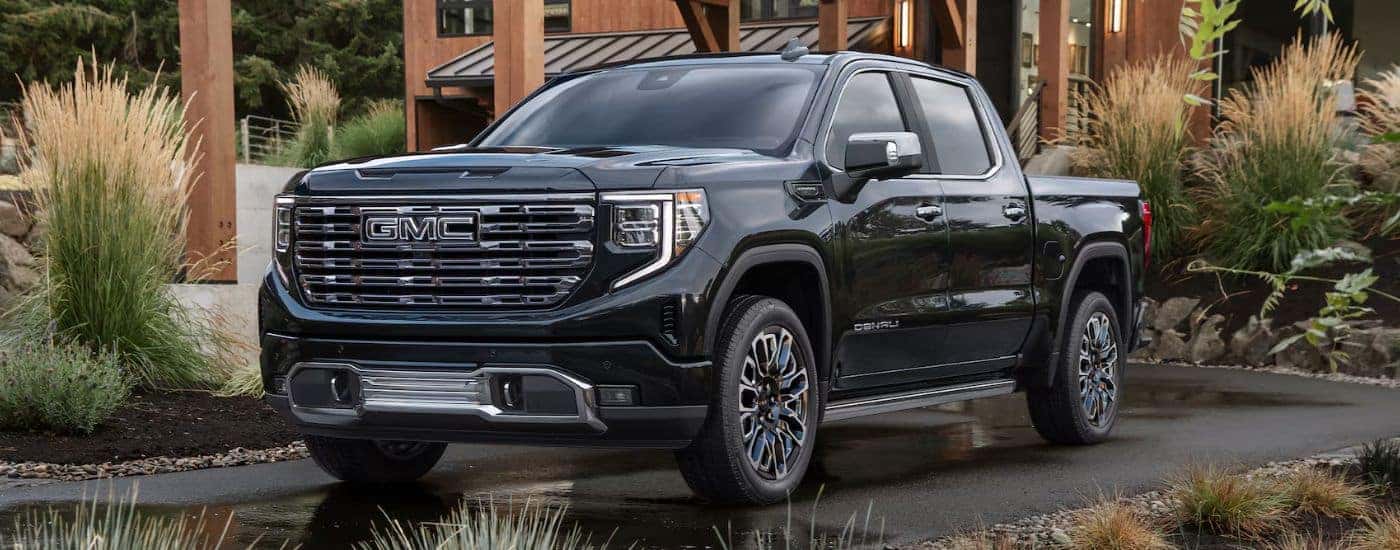 Black 2026 GMC Sierra 1500 Denali parked in a driveway.