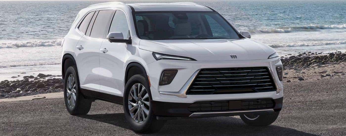 A white 2026 Buick Enclave parked on a beach.