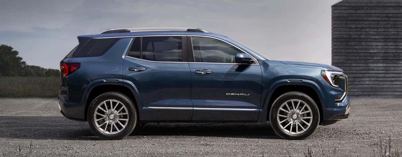 A blue 2026 GMC Terrain Denali side-view parked.