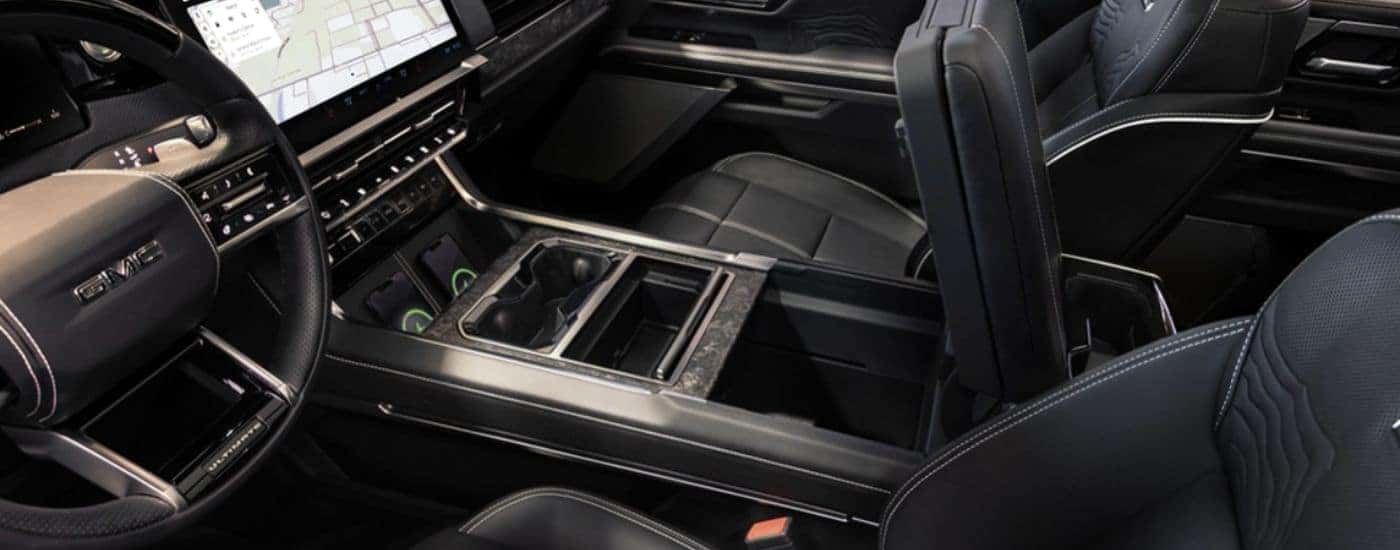 The front interior of a 2027 GMC Sierra 1500 with Multi Pro Console.