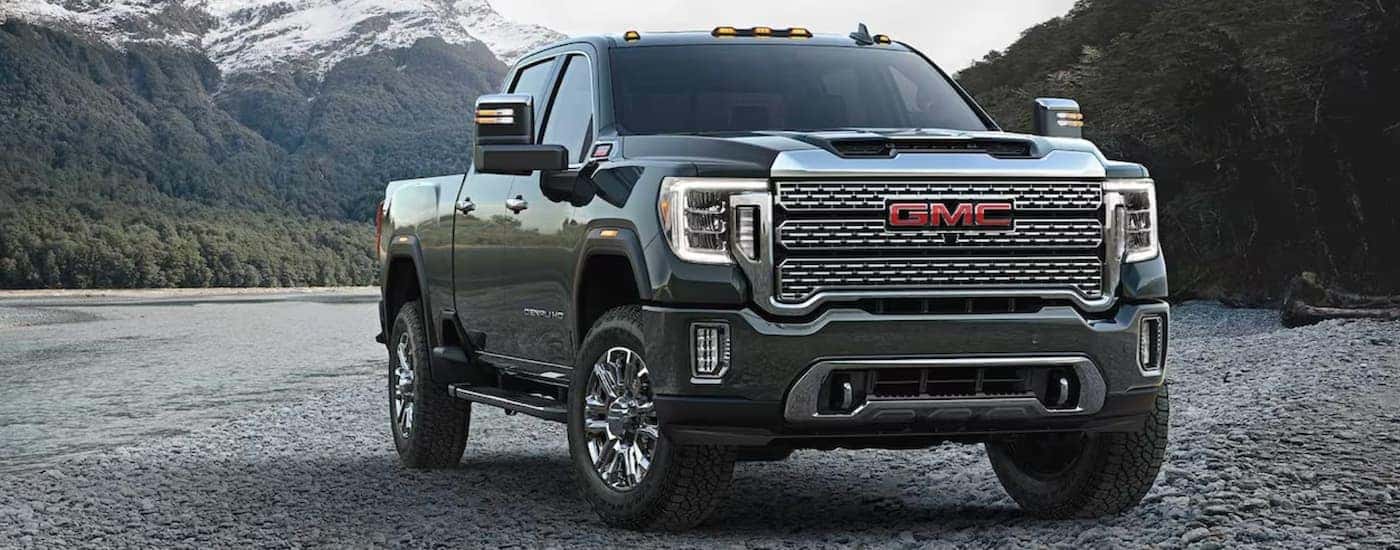 A green 2023 GMC Sierra 2500 HD parked off-road.
