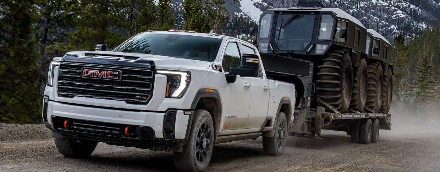 A white 2026 GMC Sierra 2500 HD towing a trailer.
