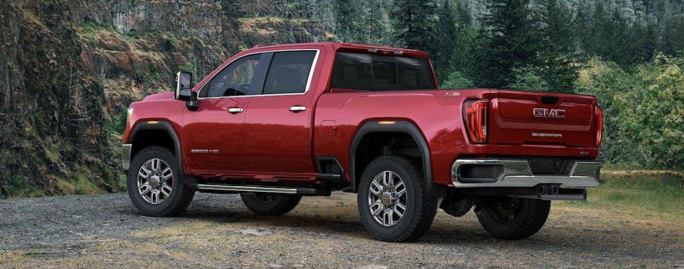 Rear view of a red 2020 GMC Sierra 2500 HD parked off-road.