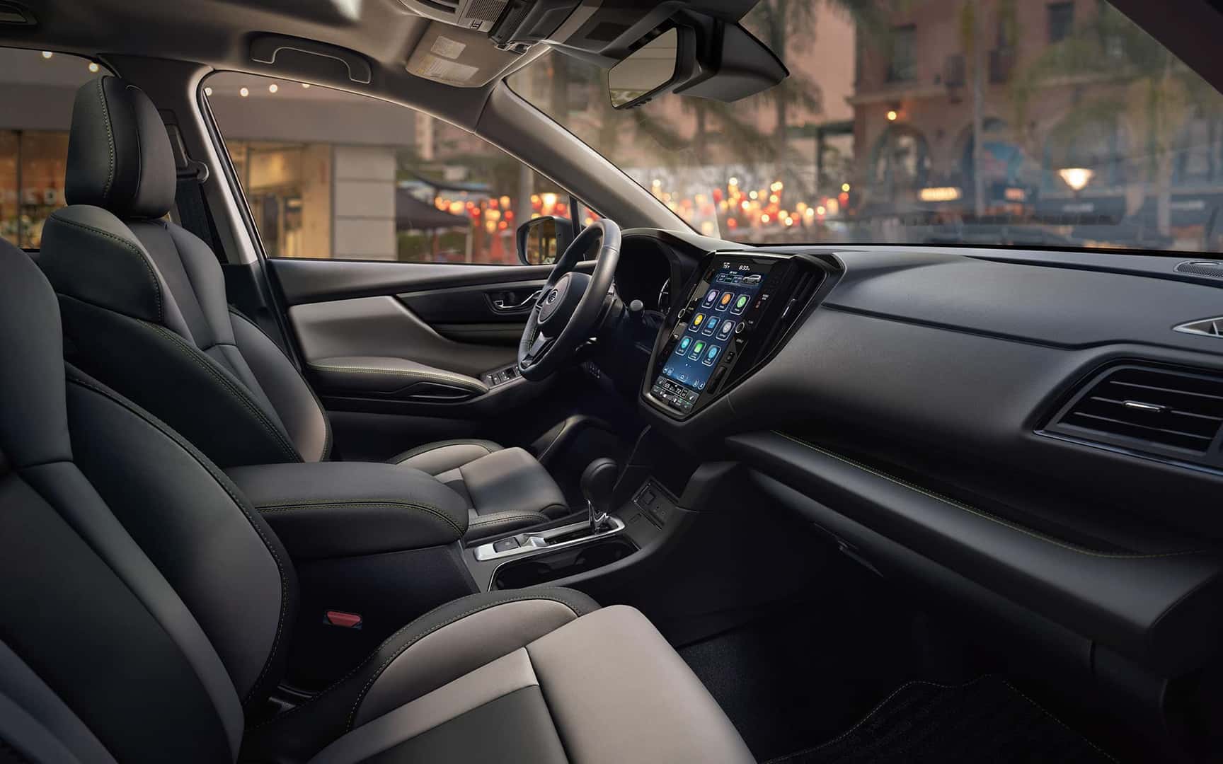 Passenger-side interior profile major with village market and city scene in background at golden hour