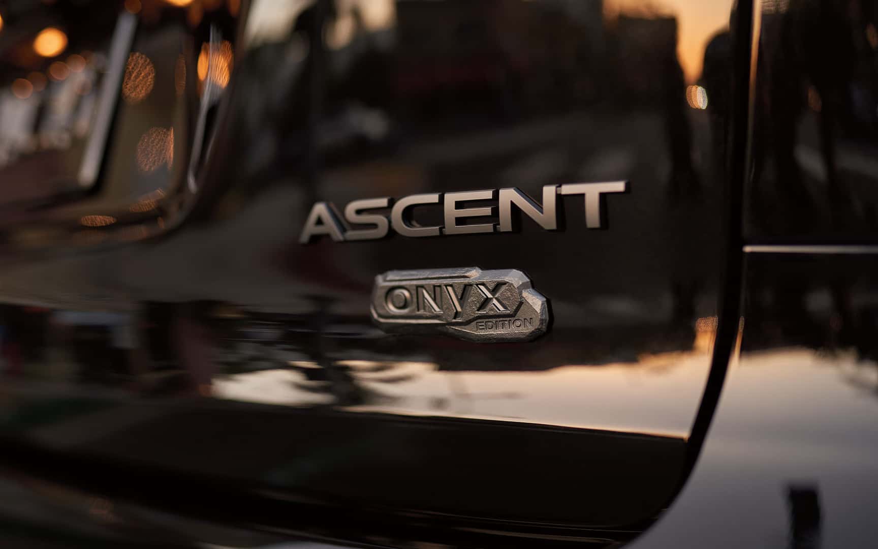 Tight shot of Ascent Onyx edition badge on rear of vehicle with hint of golden hour reflections