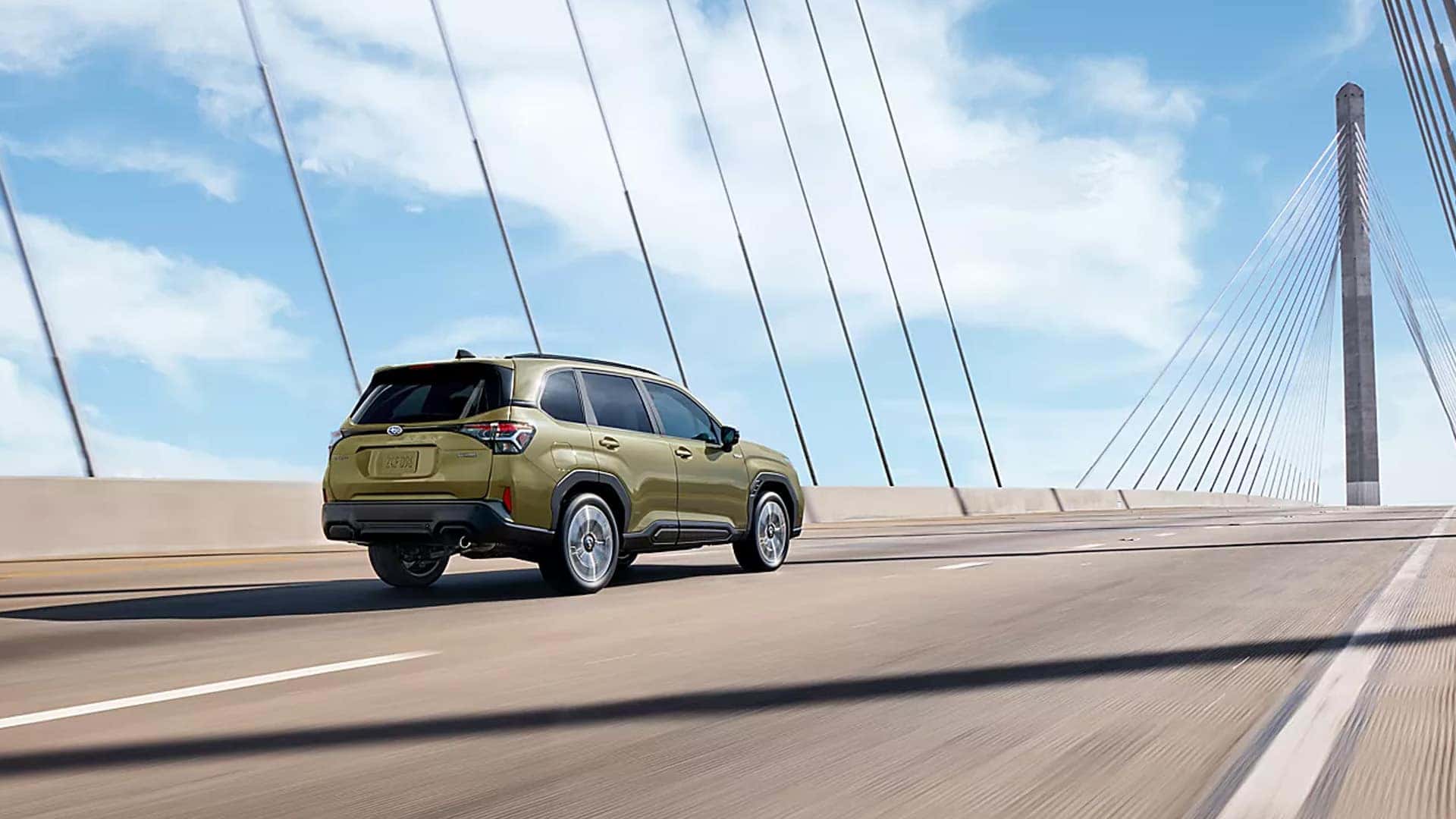 Back view of 2026 Subaru Forester Hybrid driving on a bridge