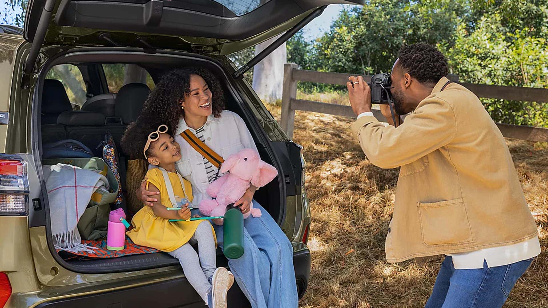 Man taking photo of family in trunk of 2026 Subaru Forester Hybrid