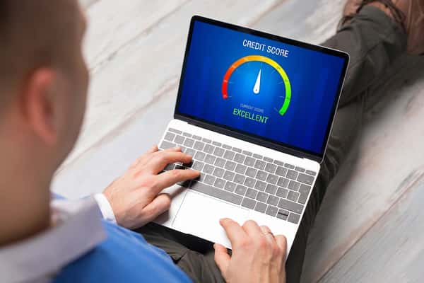 Customer checking their credit score on a laptop before applying for a car loan