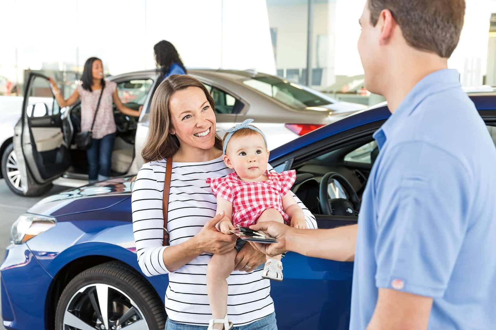 customer with baby at subaru dealership