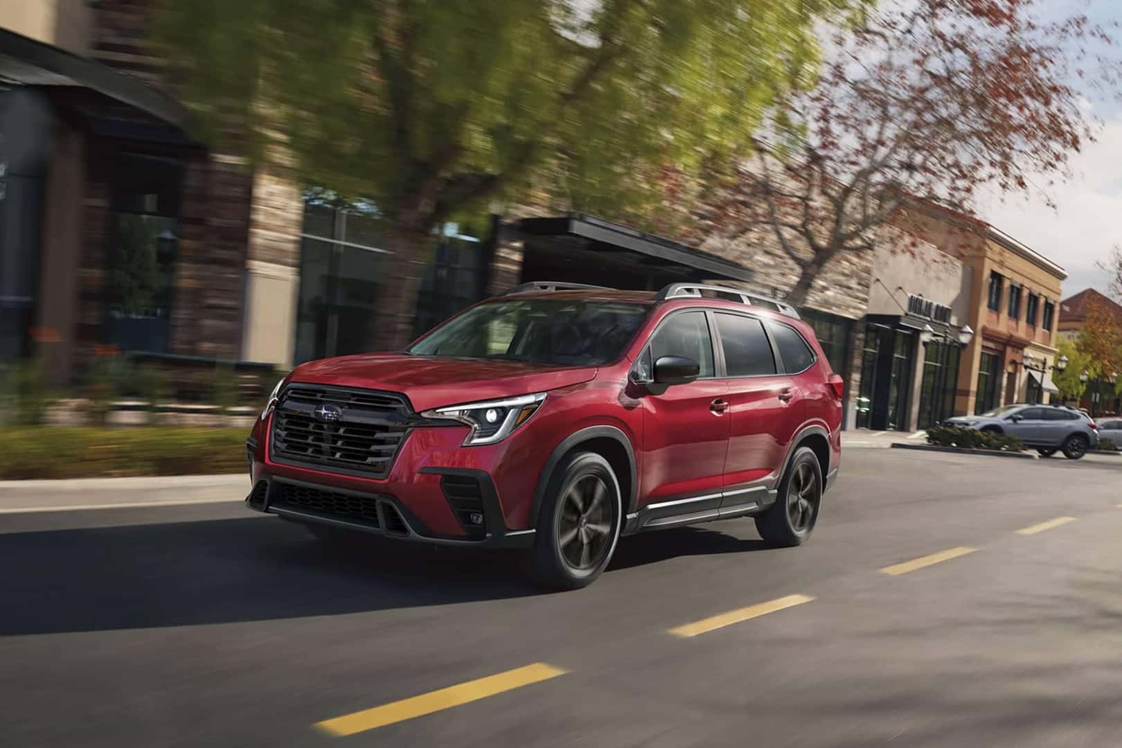 red ascent driving on neighborhood street