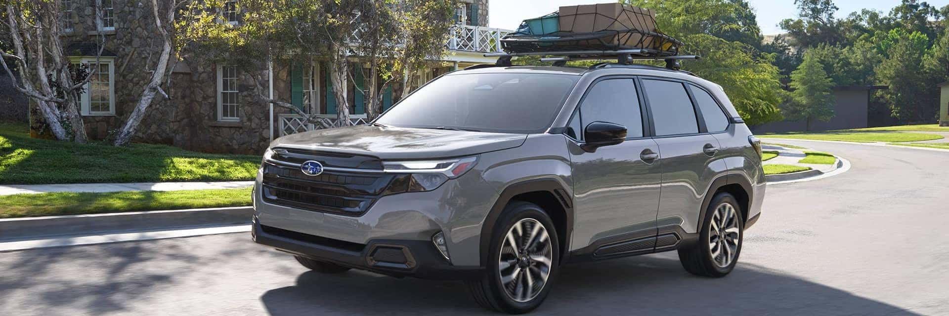 2025 subaru forester driving with luggage on top of vehicle