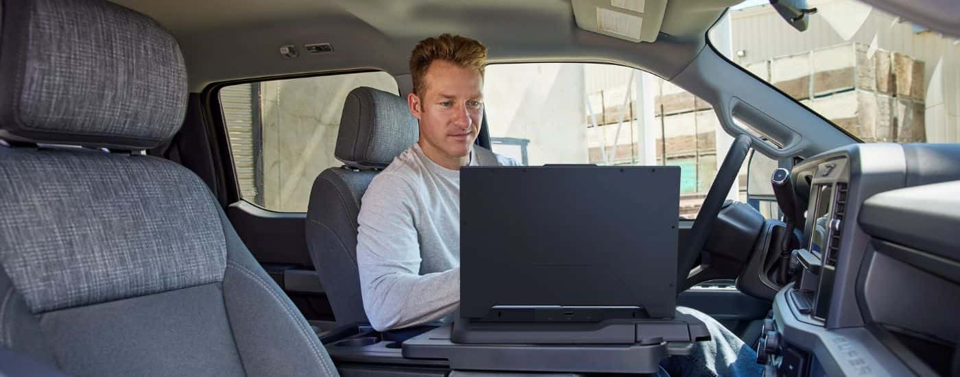 A person using their laptop inside a 2026 Ford Super Duty F-250 XL.