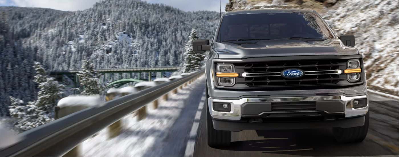 A gray 2026 Ford F-150 front-view driving.