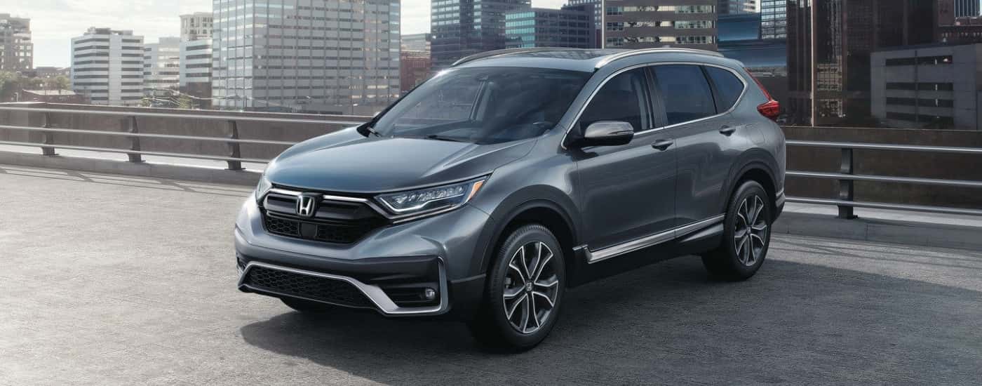 Grey 2020 Honda CR-V parked on the top floor of a parking garage in a city