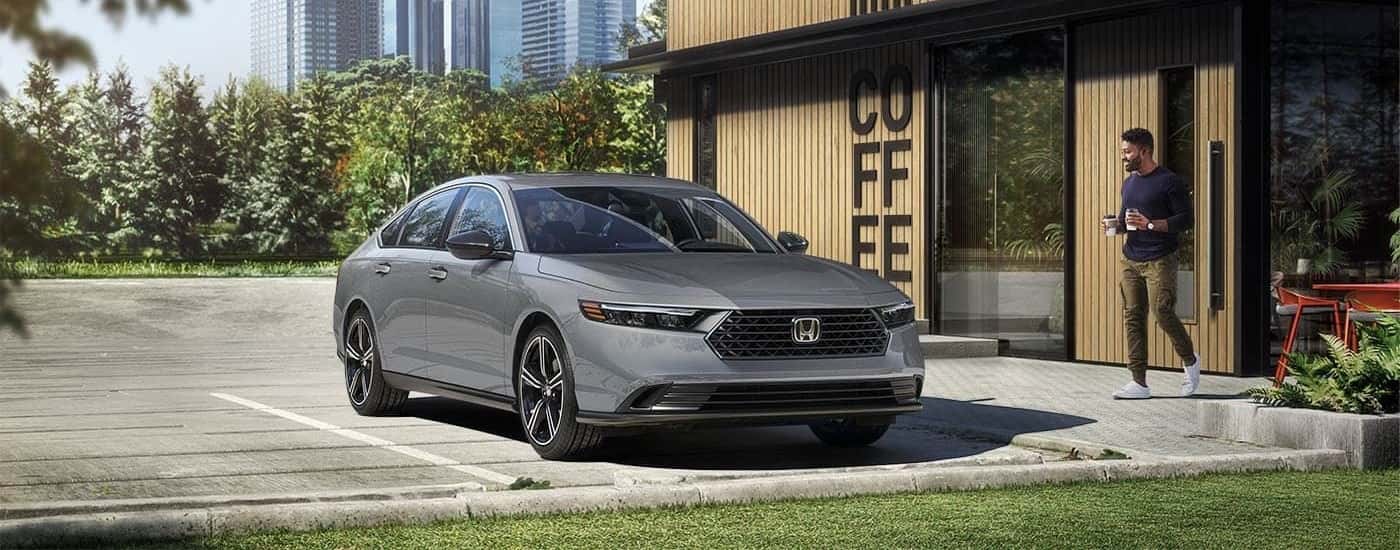 Grey 2023 Honda Accord Sport Hybrid parked near a coffee shop