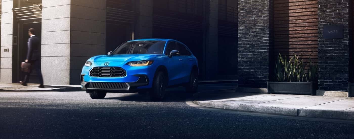 A blue 2026 Honda HR-V driving in a city