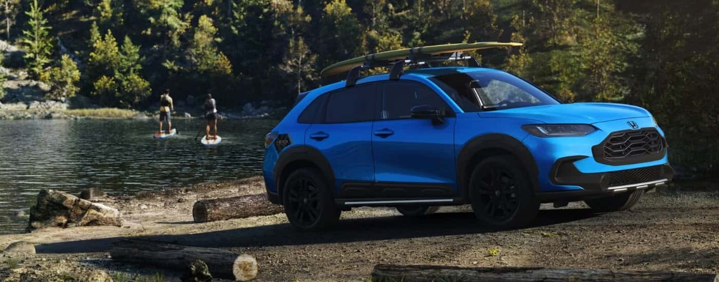 Blue 2027 Honda HR-V parked by a lake