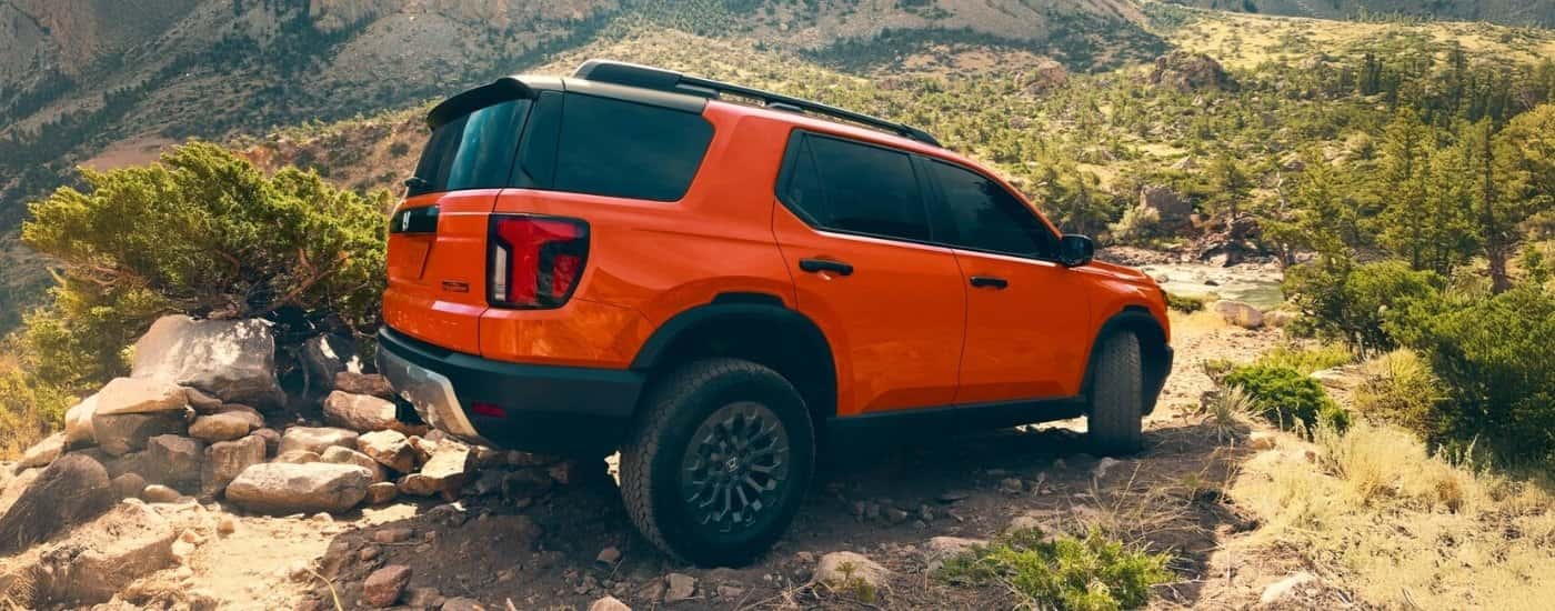 Orange 2026 Honda Passport TrailSport off-roading