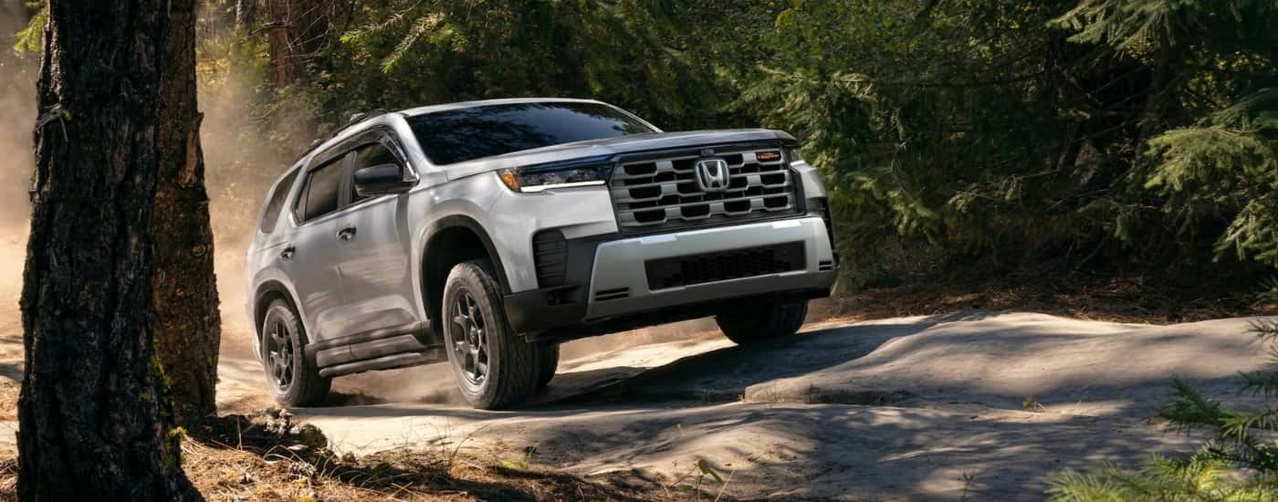 Silver 2026 Honda Pilot TrailSport driving off-road