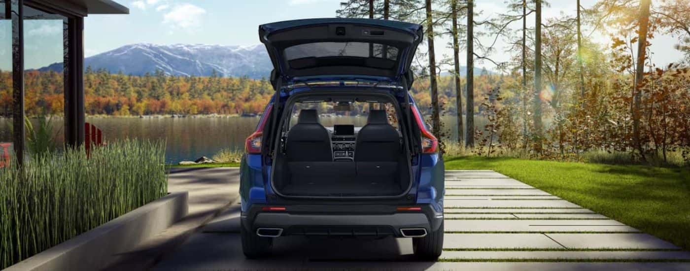 Open cargo area of a blue 2023 Honda CR-V 