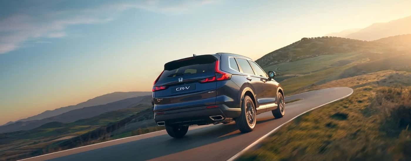 Blue 2025 Honda CR-V Hybrid driving on a highway