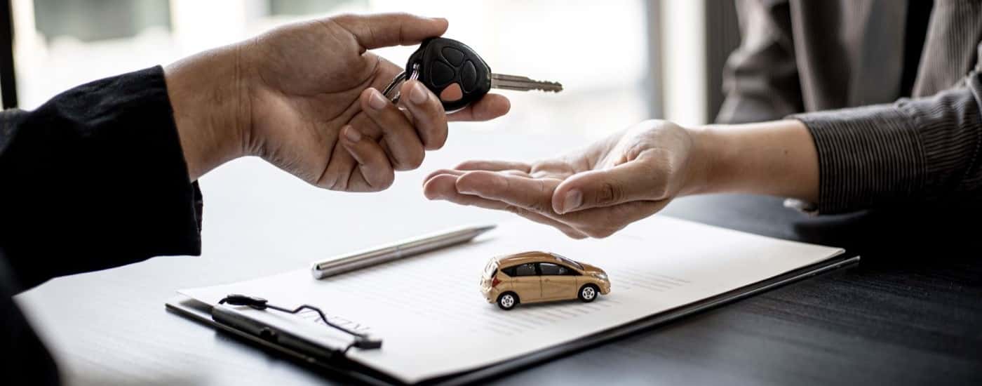 People exchanging a car key
